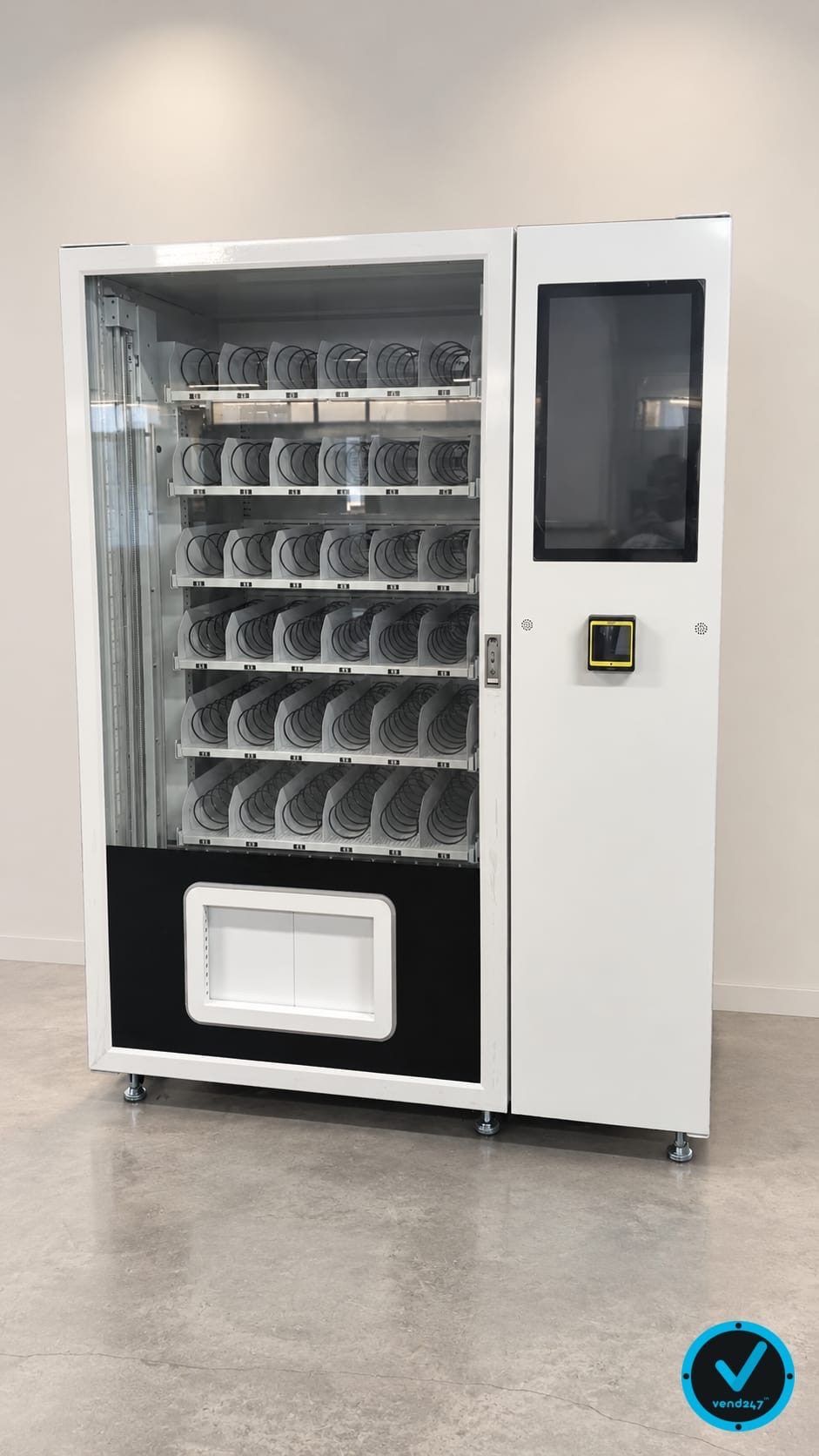 WanderVend pilot machine with six rows of spiral coils behind a full-height glass front